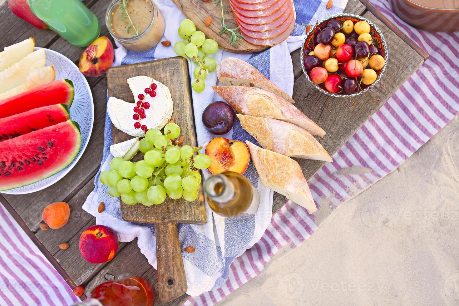 Picnic on the beach at sunset in the style of boho photo