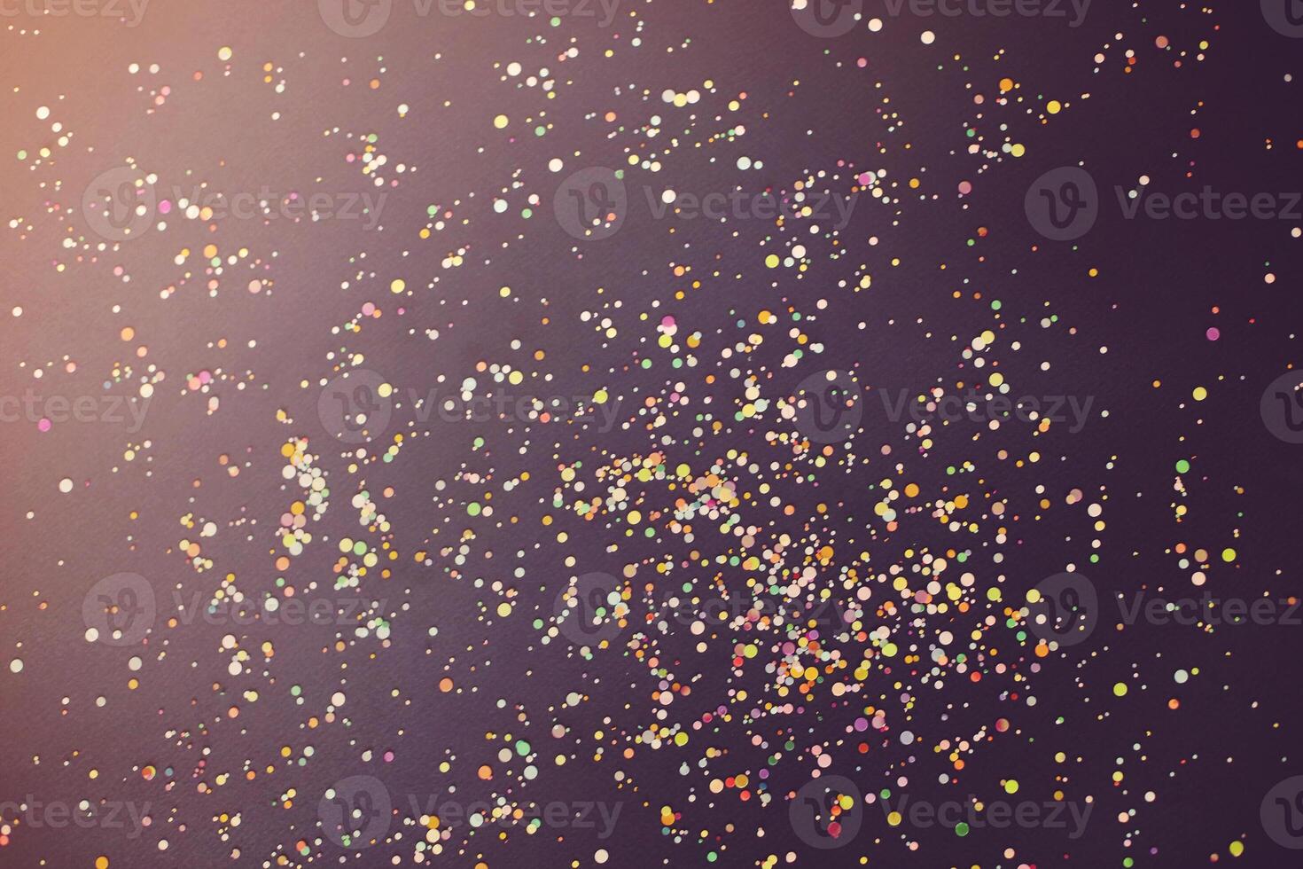 Colorful confetti on dark table photo