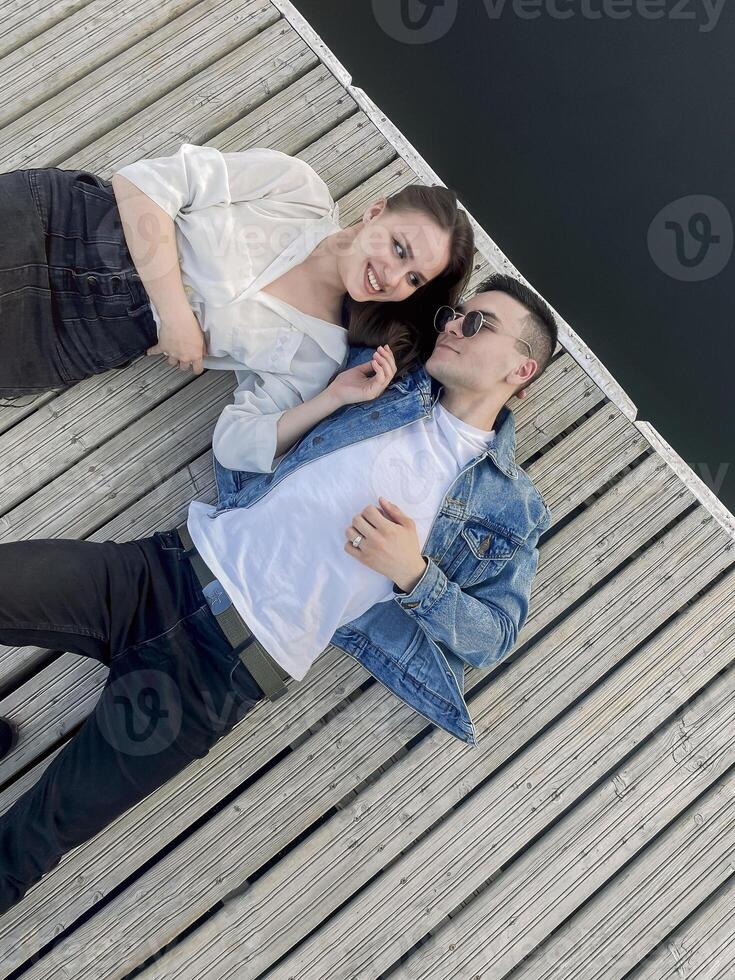 Young couple relaxing on pier in summer photo