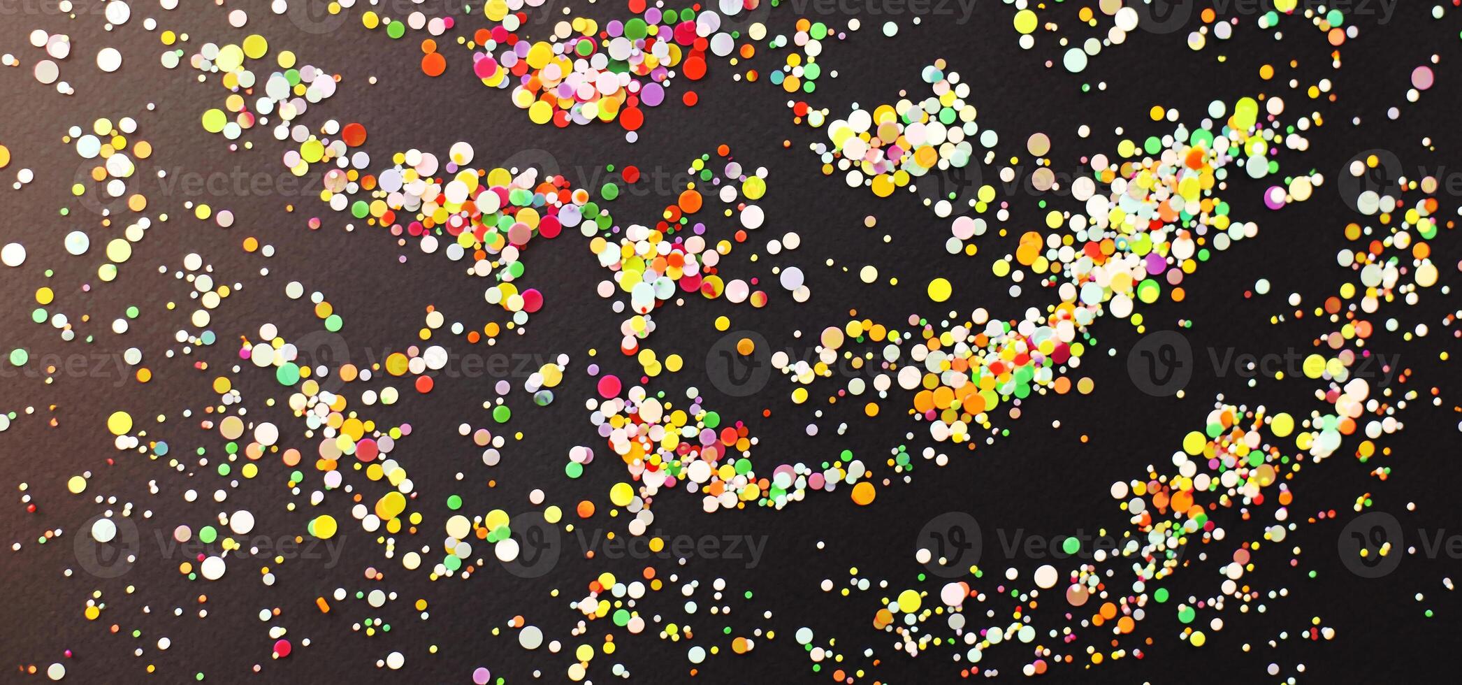 Colorful confetti on dark table photo