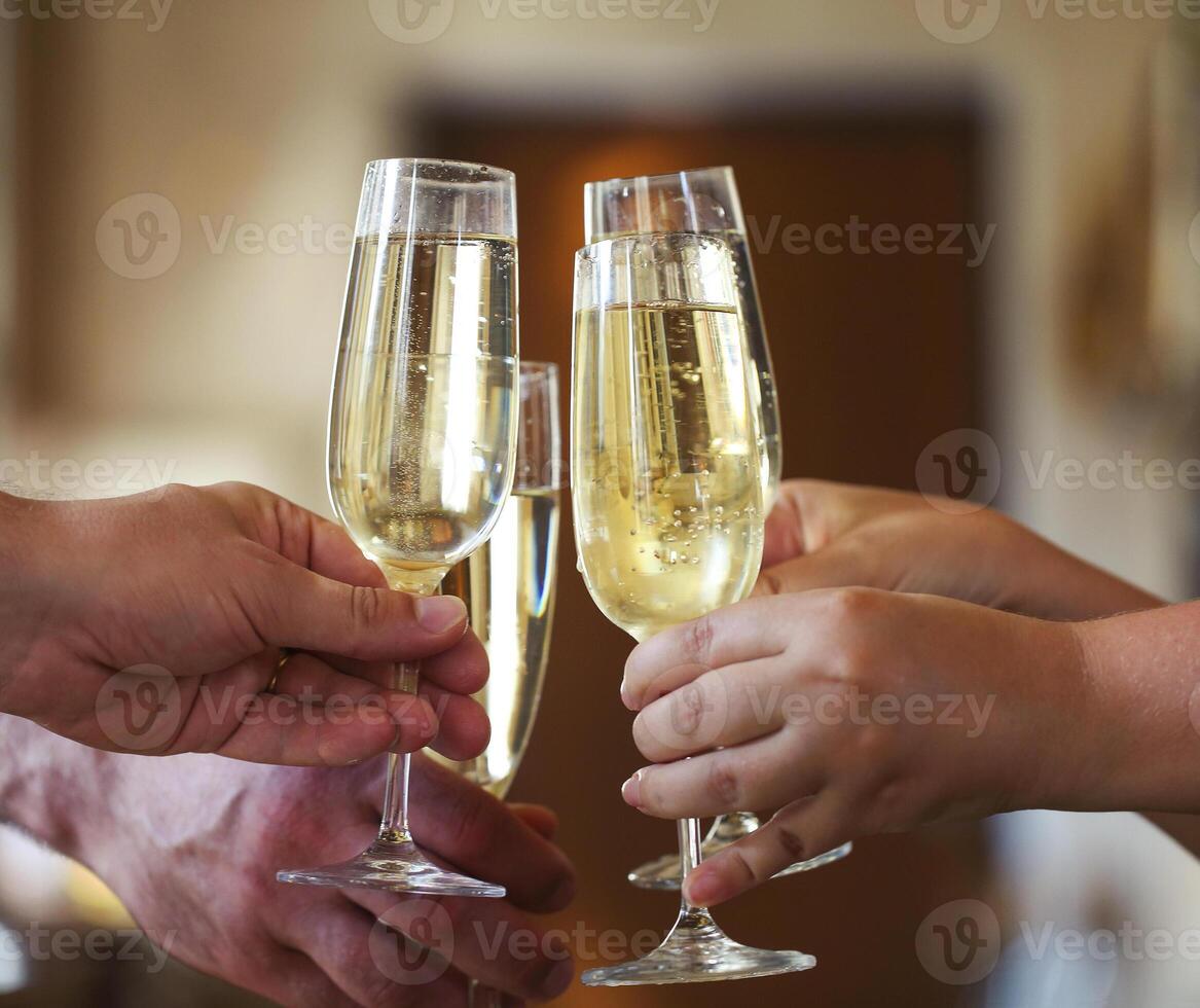 People holding glasses of champagne making a toast photo