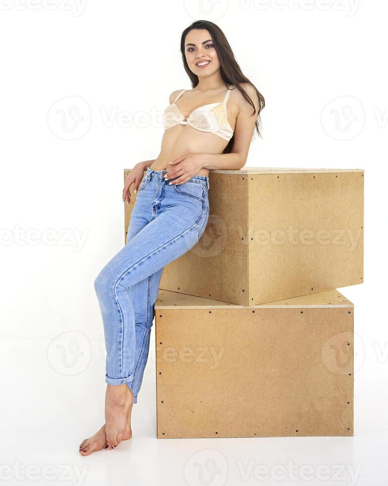 Attractive cute blrunette woman in jeans and beige bra photo