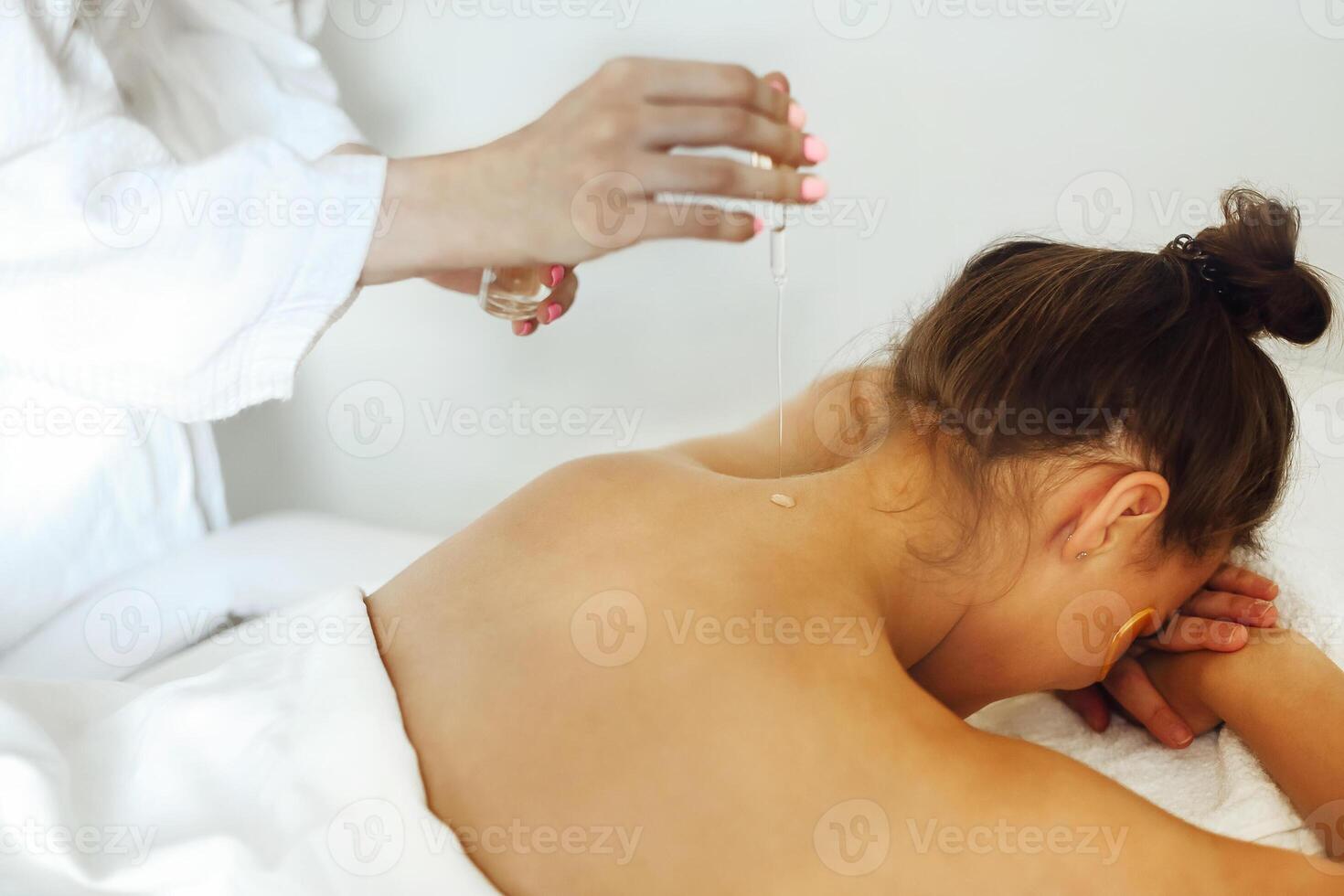 Woman on massage table in salon photo