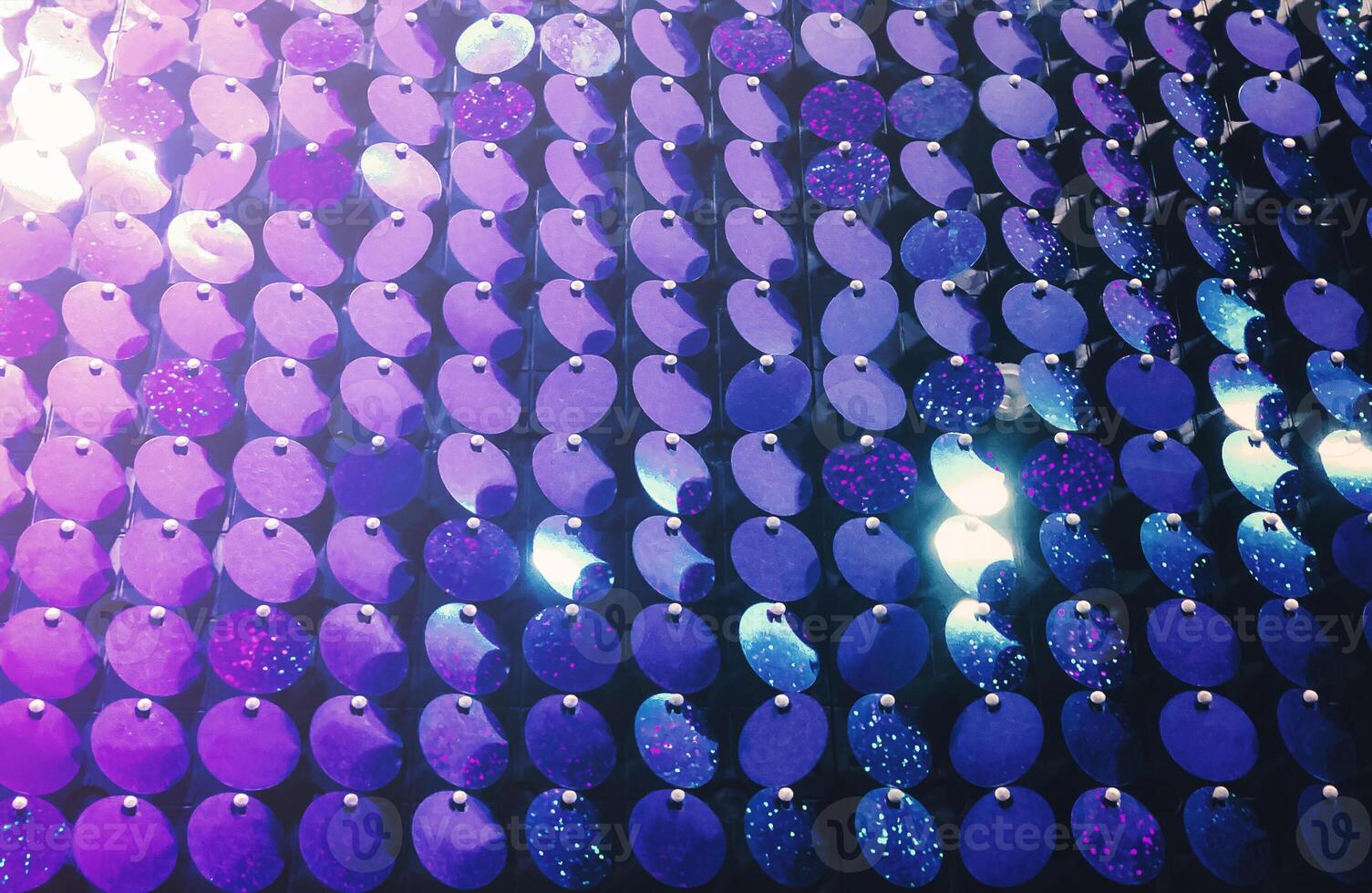 Colorful background of glowing sequins photo