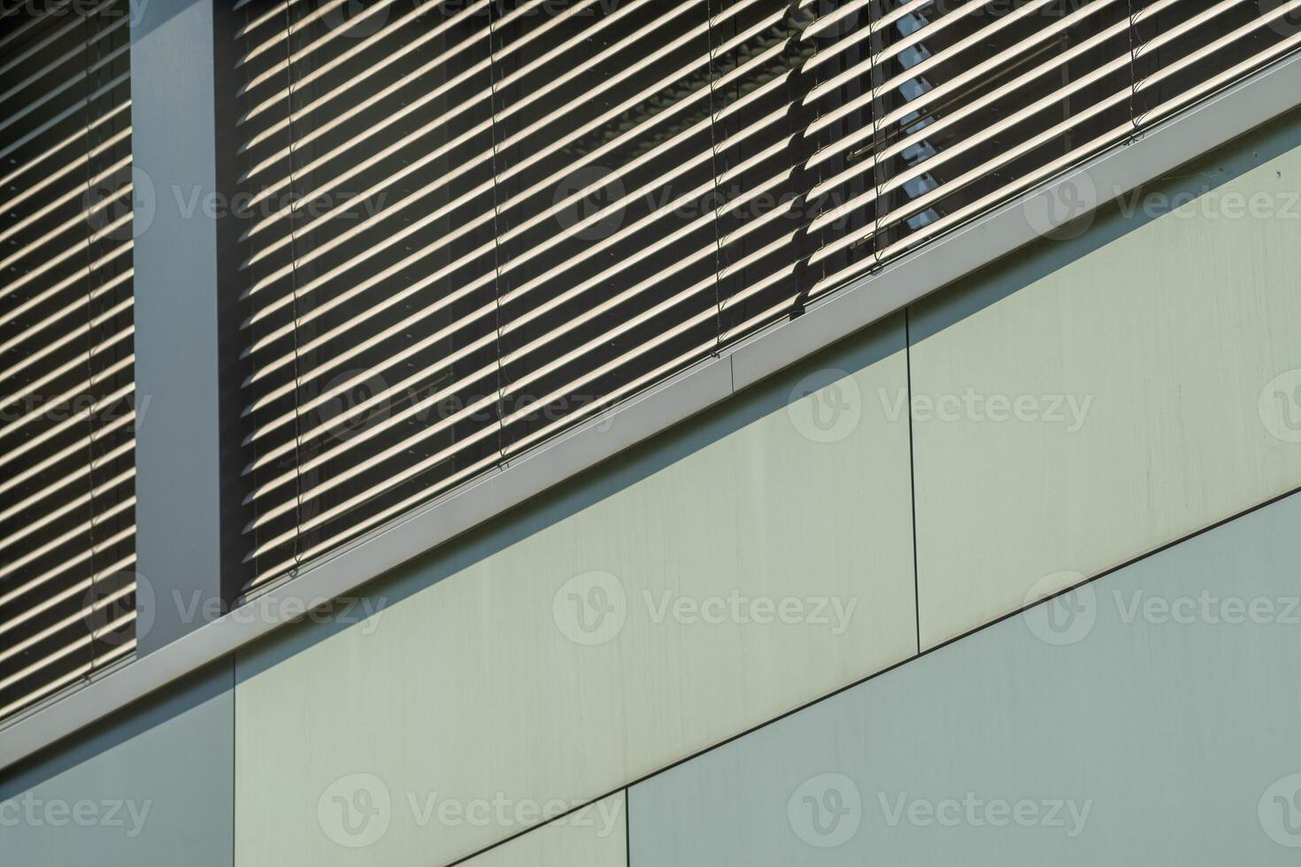 office building facade with windows and blinds photo