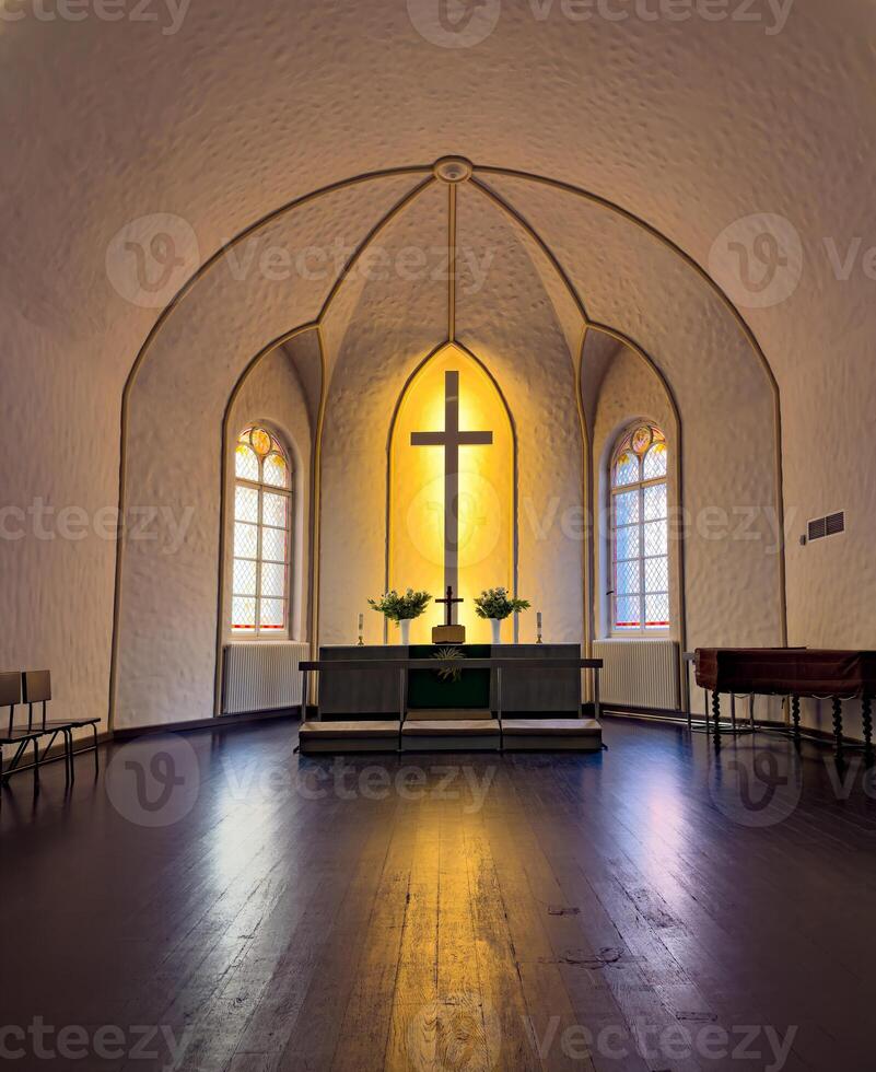 Peaceful Church Interior with Illuminated Altar and Cross photo