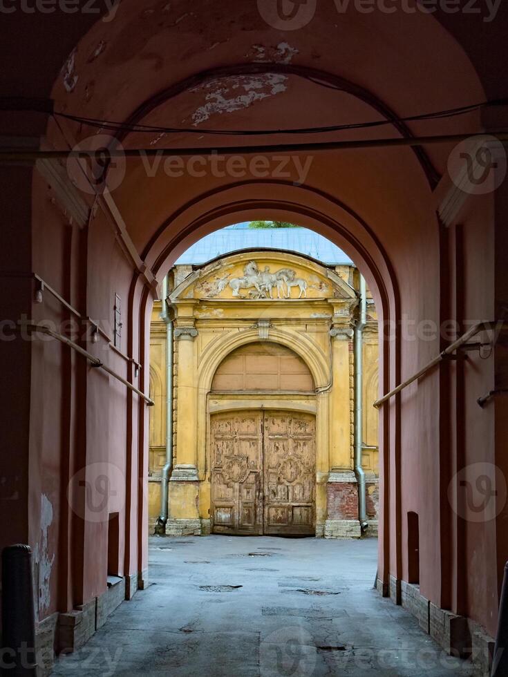 Weathered Historical Gate with Sculptures and Archway photo