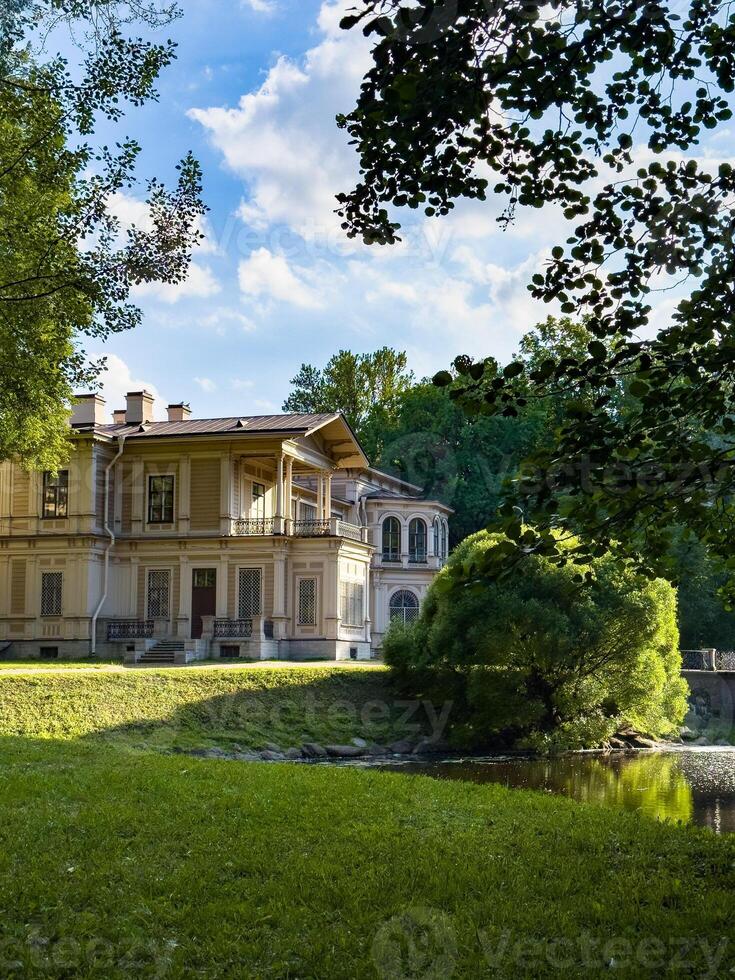 A beautifully preserved historic mansion in St. Petersburg, showcasing intricate architectural details and set against a backdrop of lush greenery. Perfect for themes of heritage, architecture, and cultural history photo