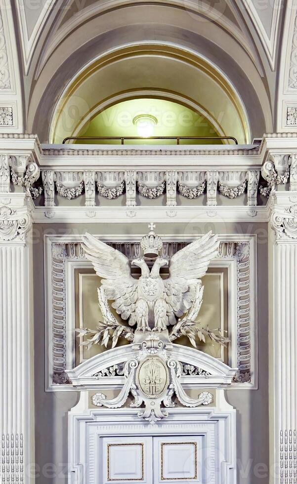 Intricate architectural details featuring a grand sculpted eagle and decorative motifs adorn the interior of a historic building, showcasing classical design elements and craftsmanship photo