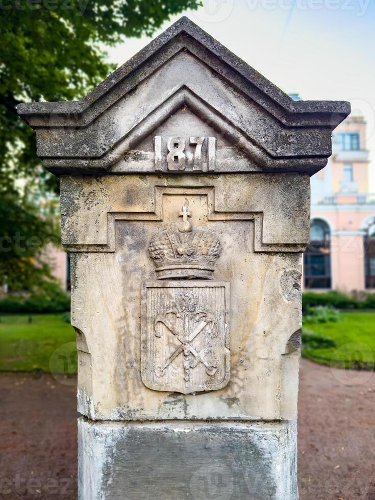 A detailed view of a historic stone monument featuring the inscription 1871 and an intricate emblem with a crown. This significant piece of architecture reflects the cultural heritage and history of the area photo