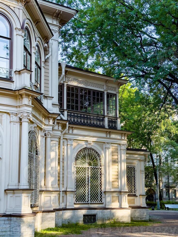 A beautifully preserved historic mansion in St. Petersburg, showcasing intricate architectural details and set against a backdrop of lush greenery. Perfect for themes of heritage, architecture, and cultural history photo