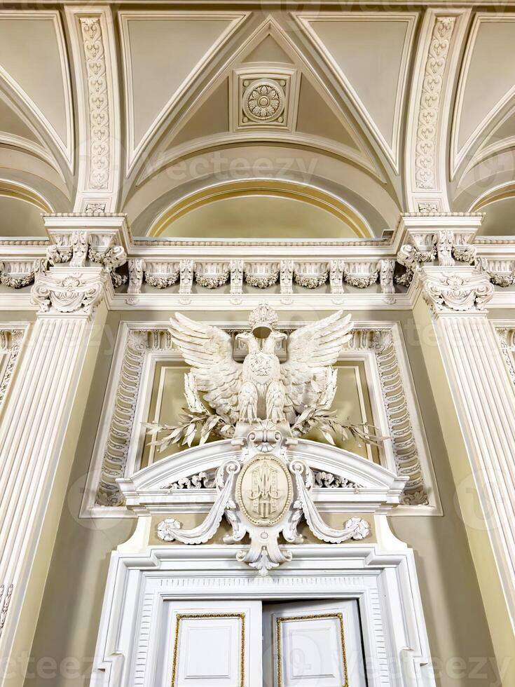 Intricate architectural details featuring a grand sculpted eagle and decorative motifs adorn the interior of a historic building, showcasing classical design elements and craftsmanship photo