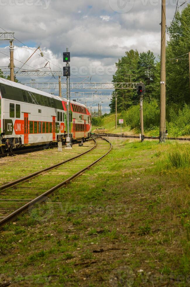 The train moves along the rails in summer in Lithuanian . High quality photo