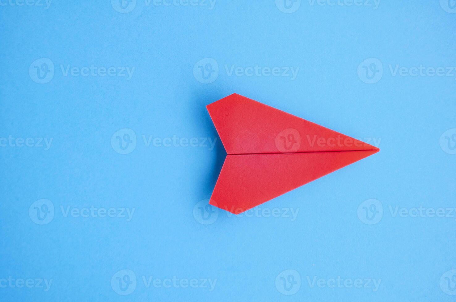 Top view of red paper airplane with customizable space for text or ideas photo