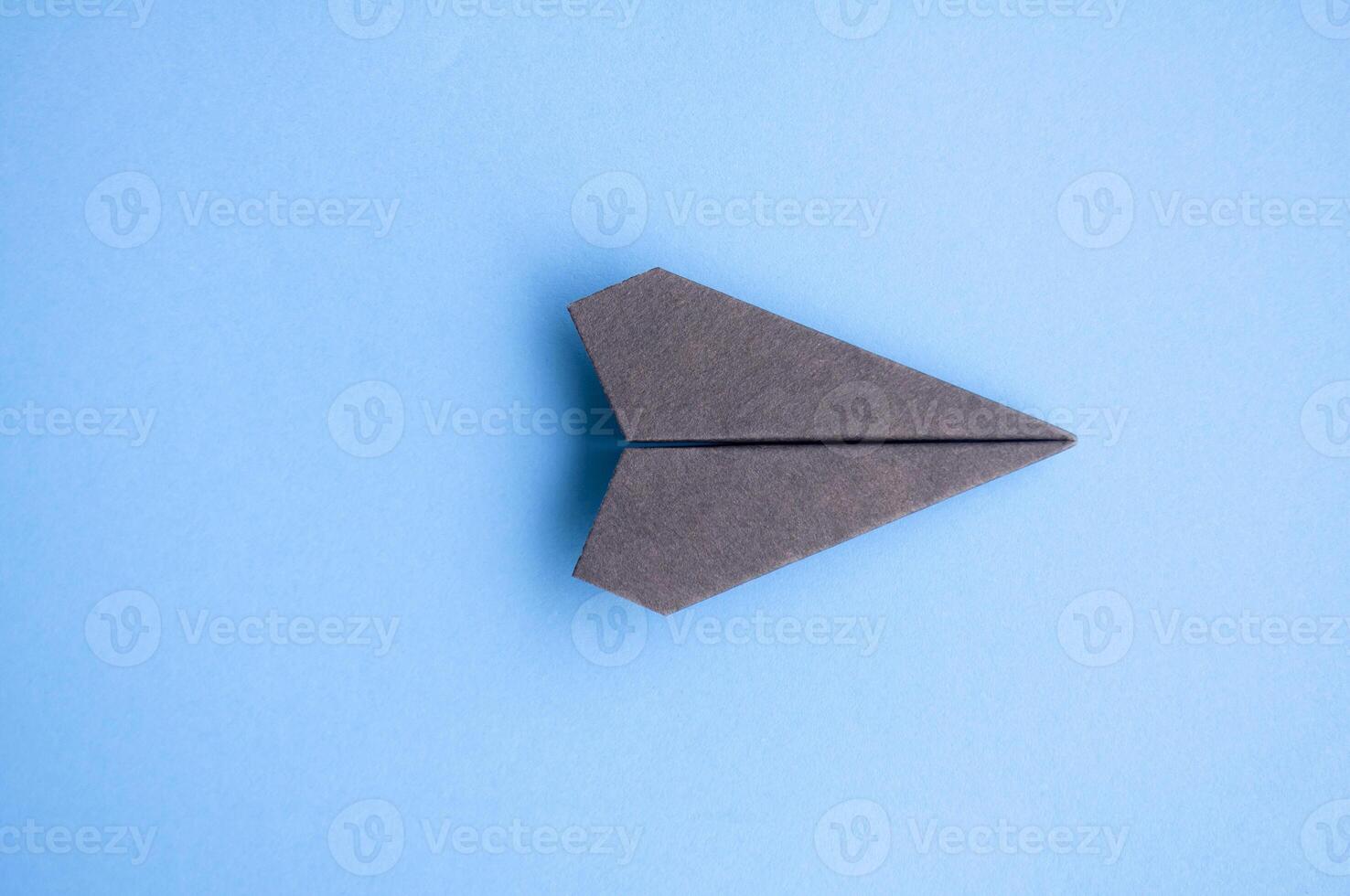 Top view of black paper airplane with customizable space for text or ideas photo