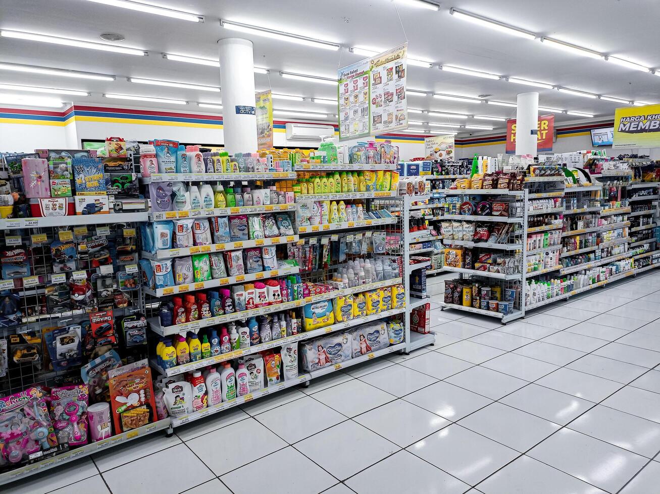 Aisle with various kinds of goods on the shelves inside Alfamart ,one of Indonesia local franchice Mini market business unit. selective Focus image. Bandung-Indonesia,February 27 2024 photo