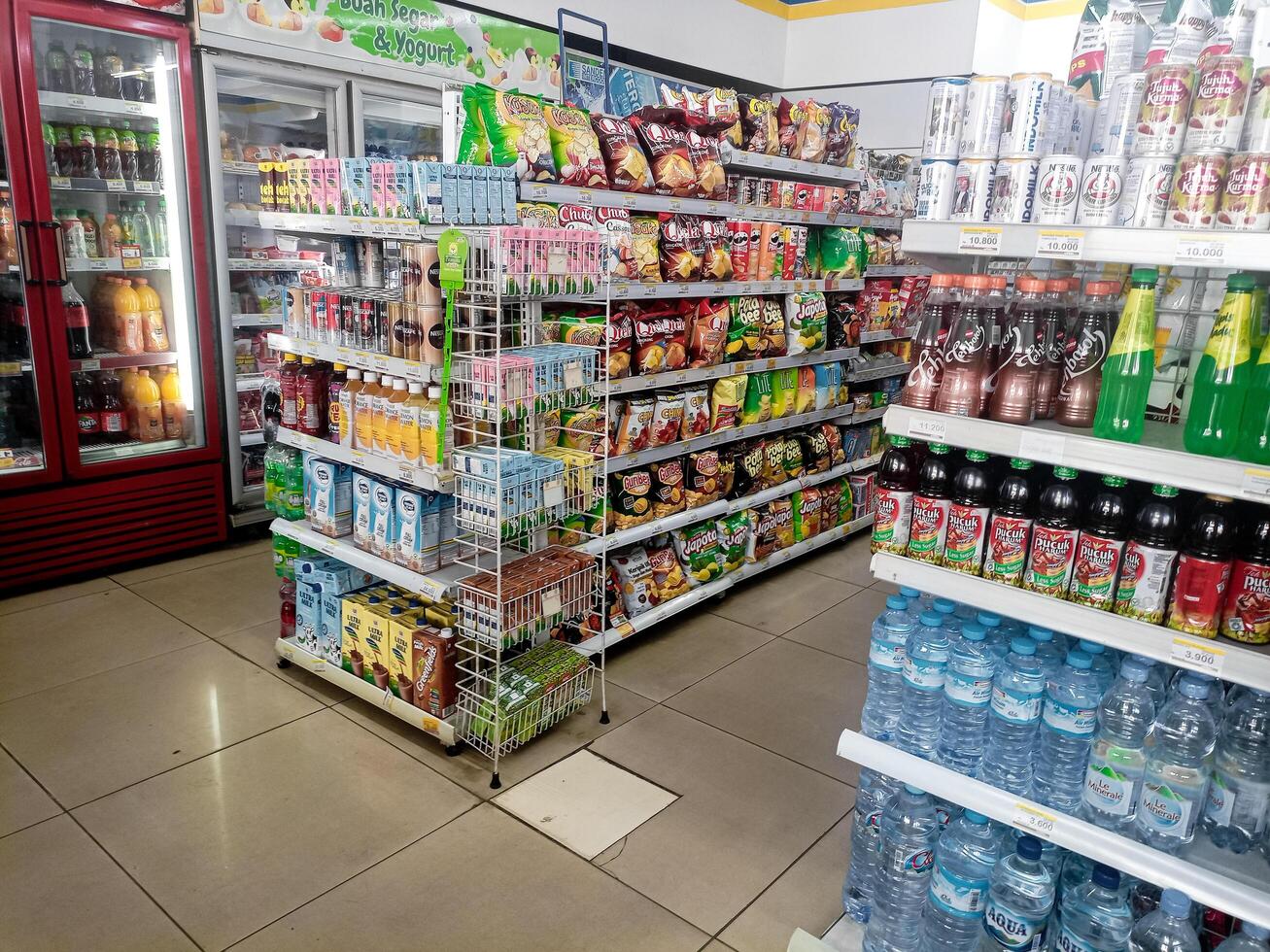 Aisle with various kinds of goods on the shelves inside Alfamart ,one of Indonesia local franchice Mini market business unit. selective Focus image. Bandung-Indonesia,February 27 2024 photo