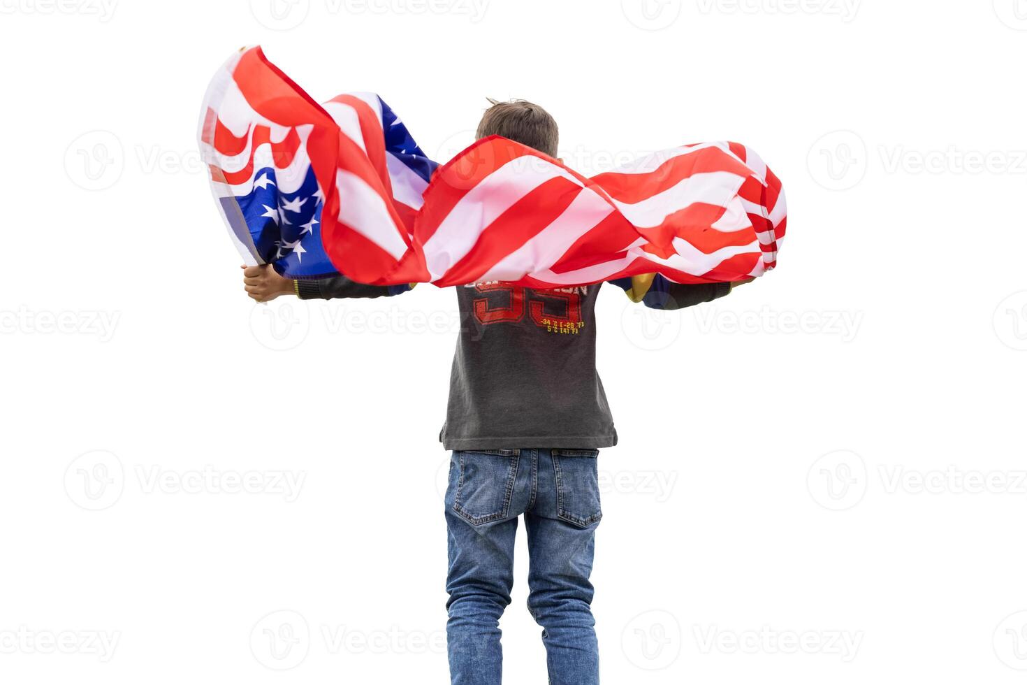 Patriotic american boy holding USA flag waving in the wind isolated on white photo