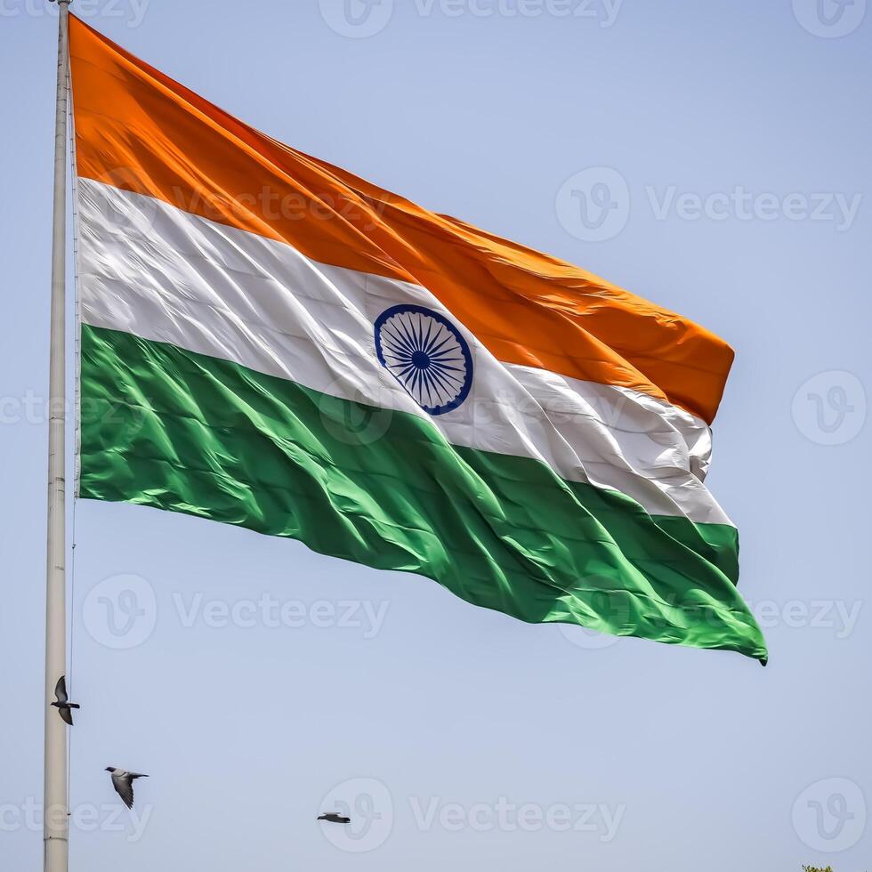India flag flying high at Connaught Place with pride in blue sky, India flag fluttering, Indian Flag on Independence Day and Republic Day of India, tilt up shot, Waving Indian flag, Har Ghar Tiranga photo