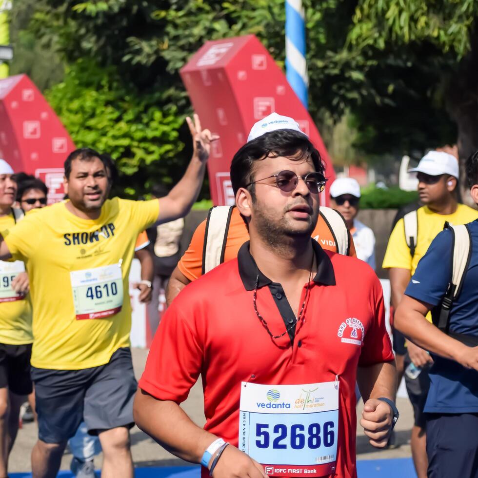 New Delhi, India - July 15 2024 - Vedanta Delhi Half Marathon race after covid in which marathon participants about to cross the finish line, Delhi Half Marathon 2023 photo