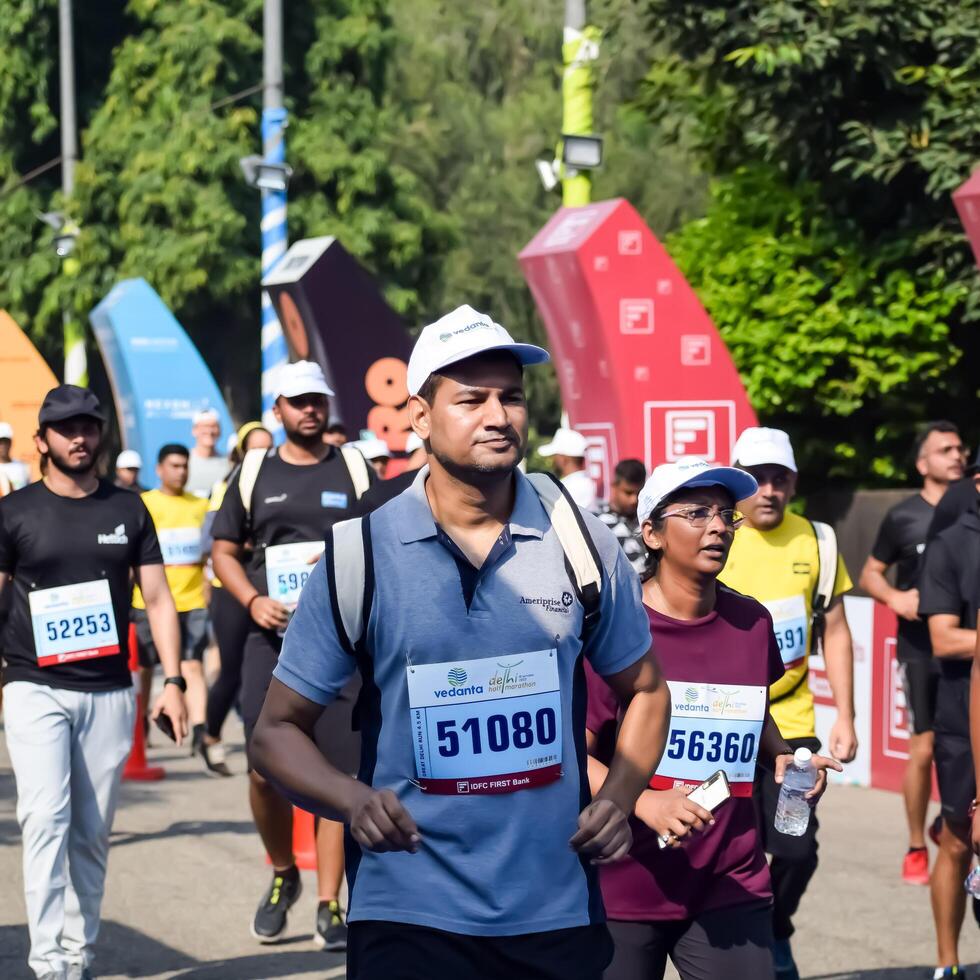 New Delhi, India - July 10 2024 - Vedanta Delhi Half Marathon race after covid in which marathon participants about to cross the finish line, Delhi Half Marathon 2023 photo