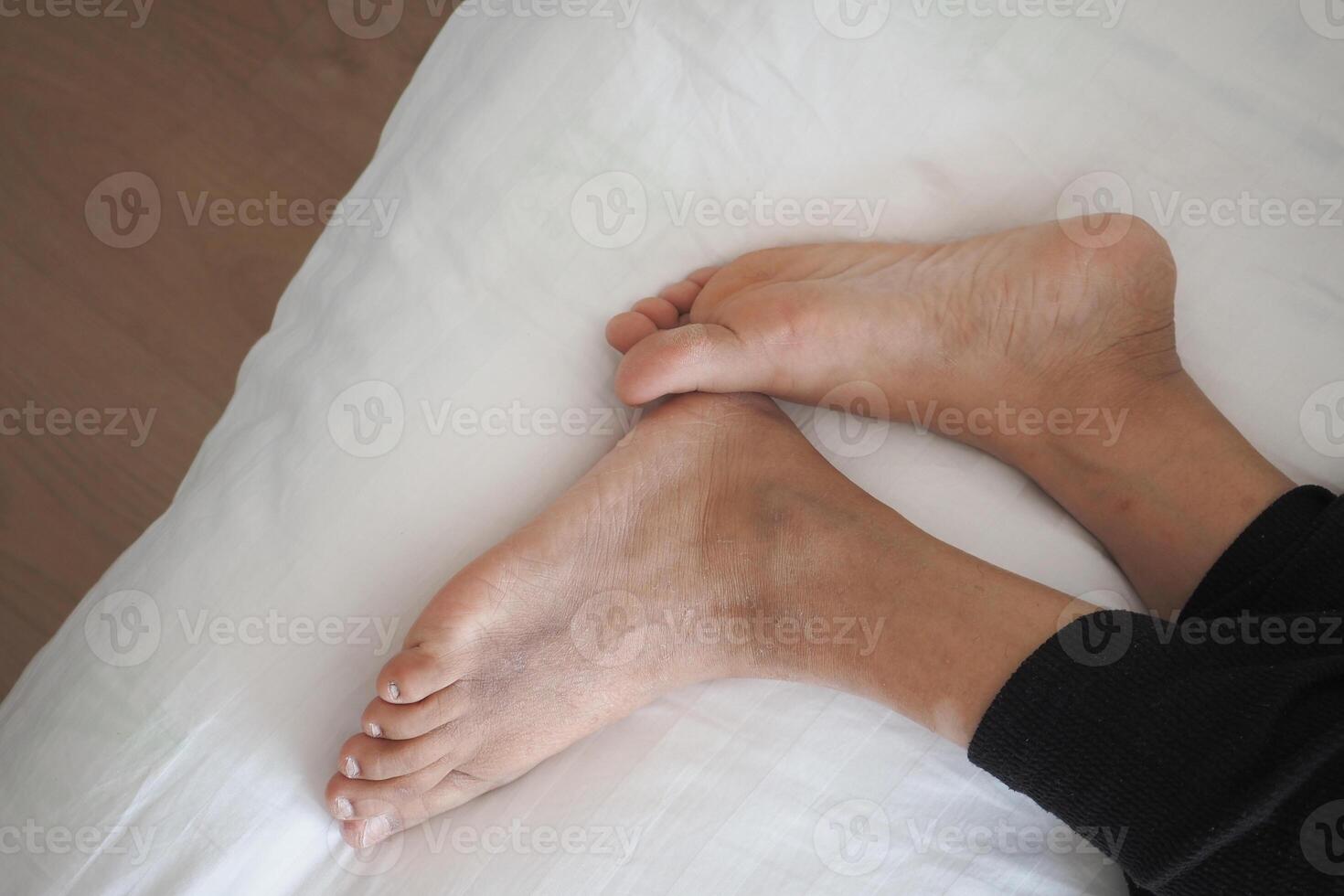 Feel the Relaxed Bare Feet on a Cozy Bed Sheet While Unwinding in Comfort and Serenity photo