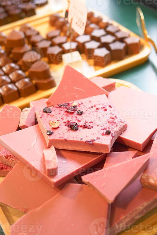 Wooden tray with magenta chocolate on a table at the event photo