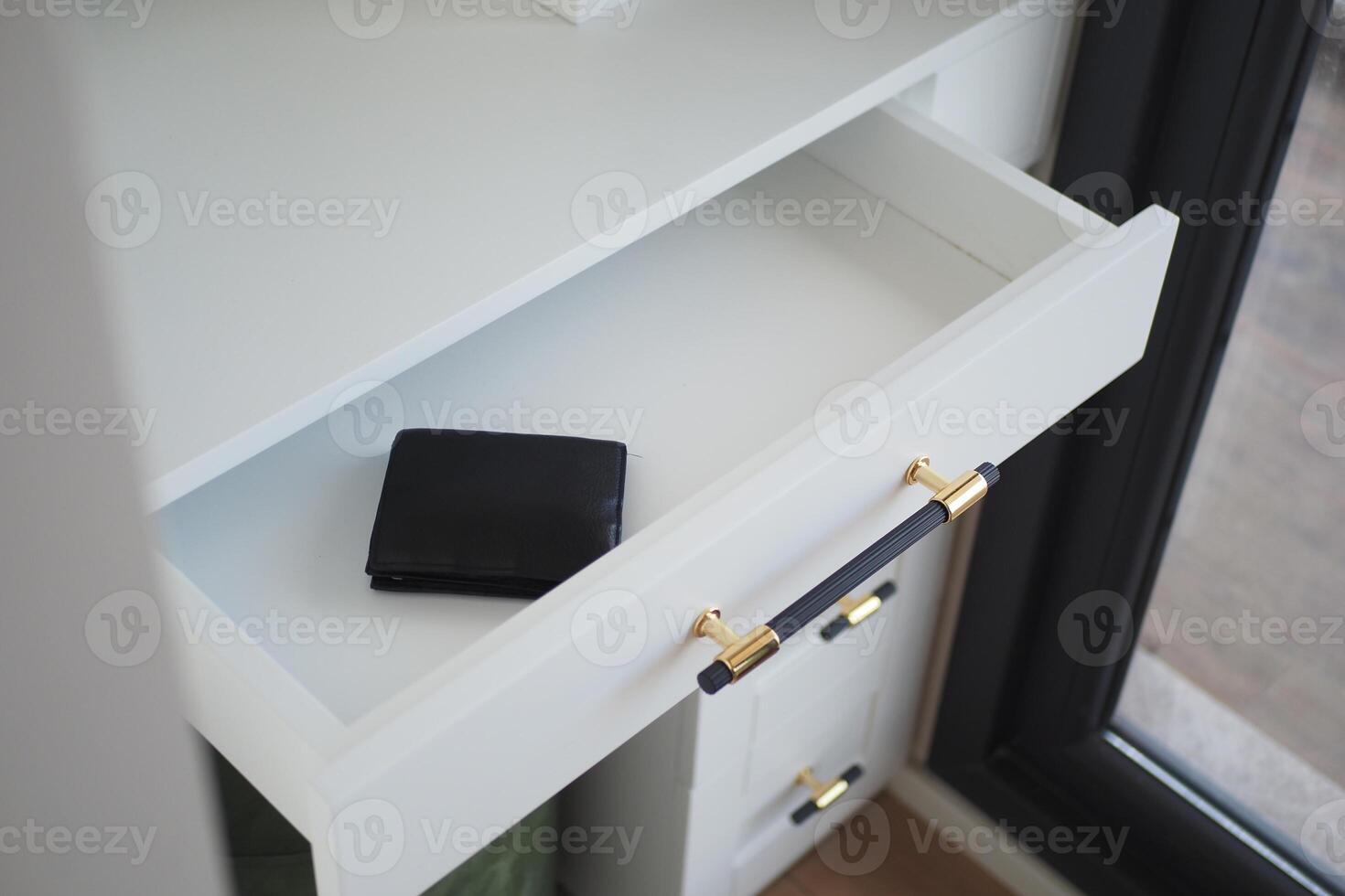 a wallet in a open drawer closeup. photo