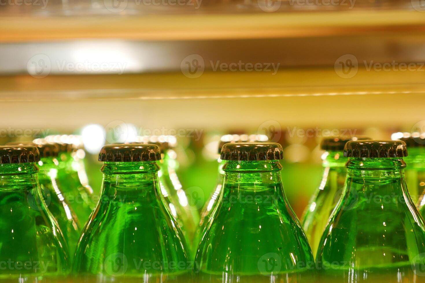 Vintage beverage bottles with colorful caps on bar shelf create a nostalgic retro drinks display photo