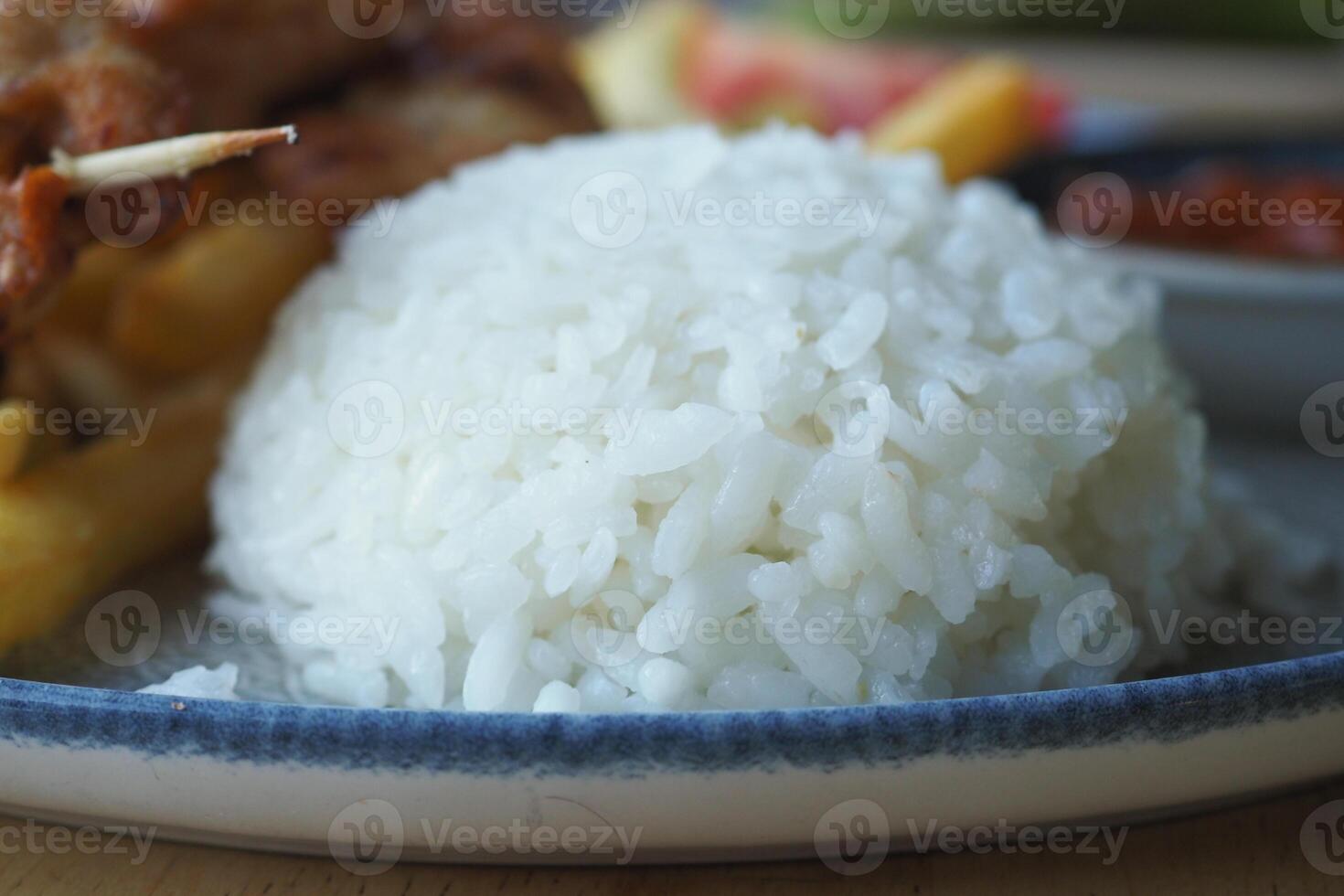 Closeup of a plate featuring white rice, French fries, and a fork, creating a delicious meal photo