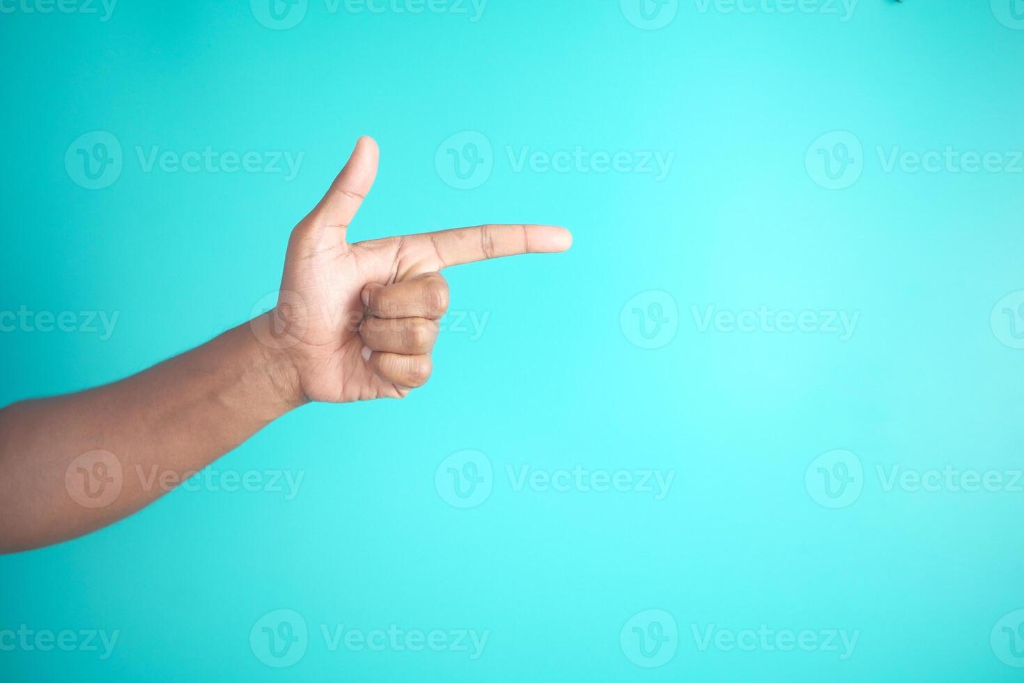 Hand Gesturing Finger Pointing on Blue Background with Minimalist Style and Symbolic Communication photo