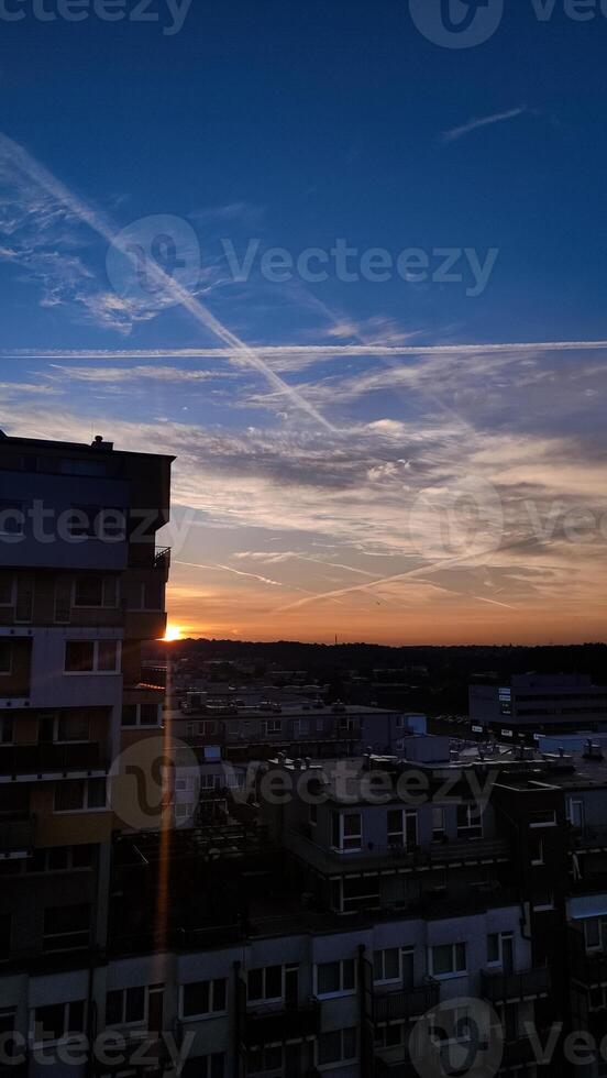 A vibrant sunset paints the sky with stunning colors over the city photo