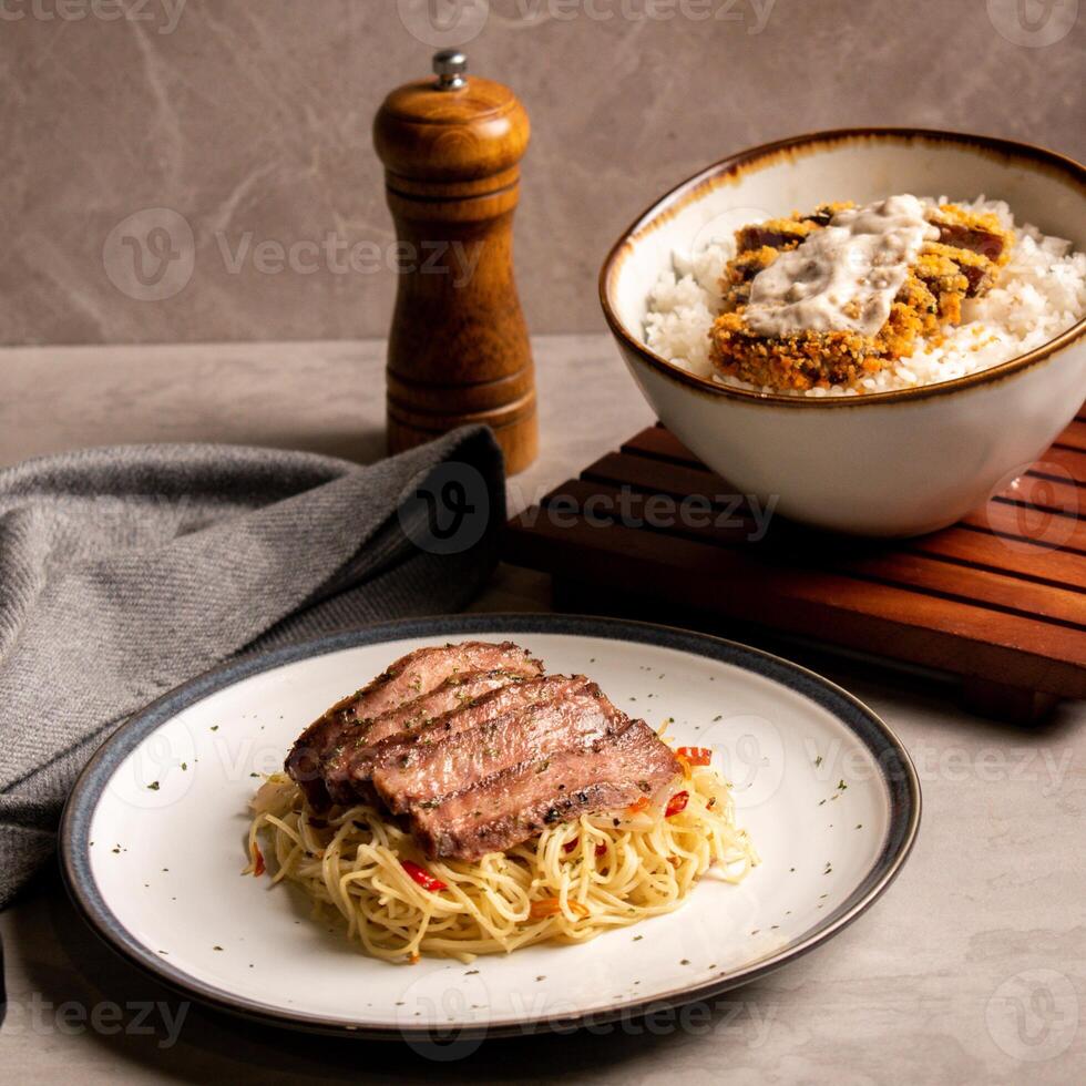 A Portion of Pasta with Beef Slices and Katsu Rice Bowl photo