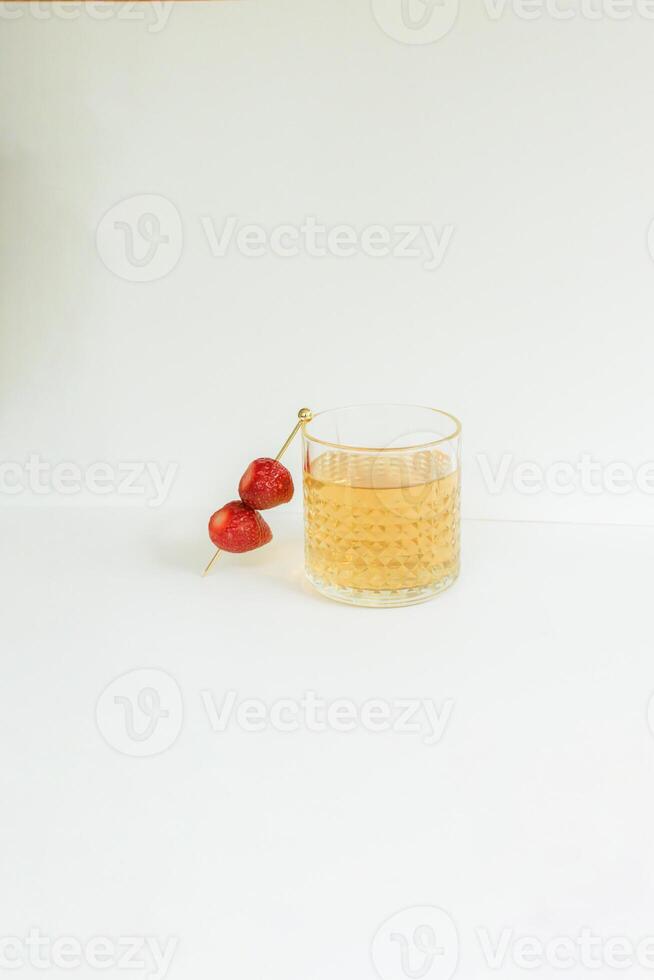 A Glass of Tea with Strawberry as a Garnish photo