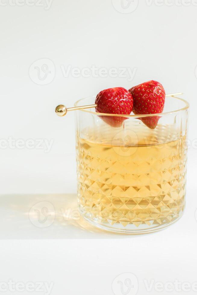 A Glass of Tea with Strawberry as a Garnish photo