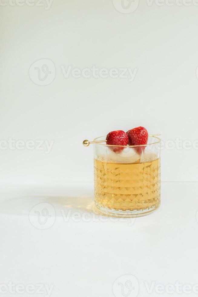 A Glass of Tea with Strawberry as a Garnish photo