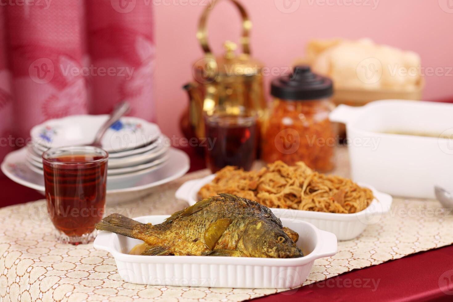 Ikan Goreng Nila Tilapia on Red Table photo