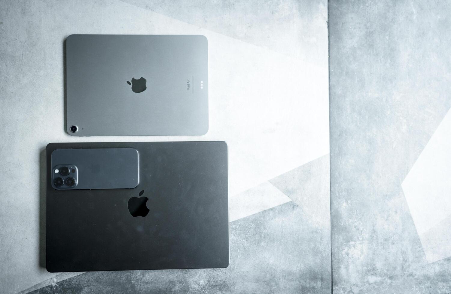 Bangkok, Thailand - August 3, 2024 Apple brand devices iPhone 15 pro, iPad air and Macbook Pro, created by Apple Inc. photo