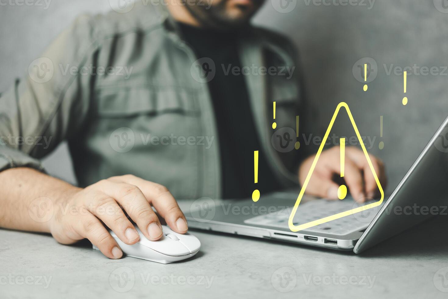 Man using computer laptop with triangle caution warning sign for notification error. photo