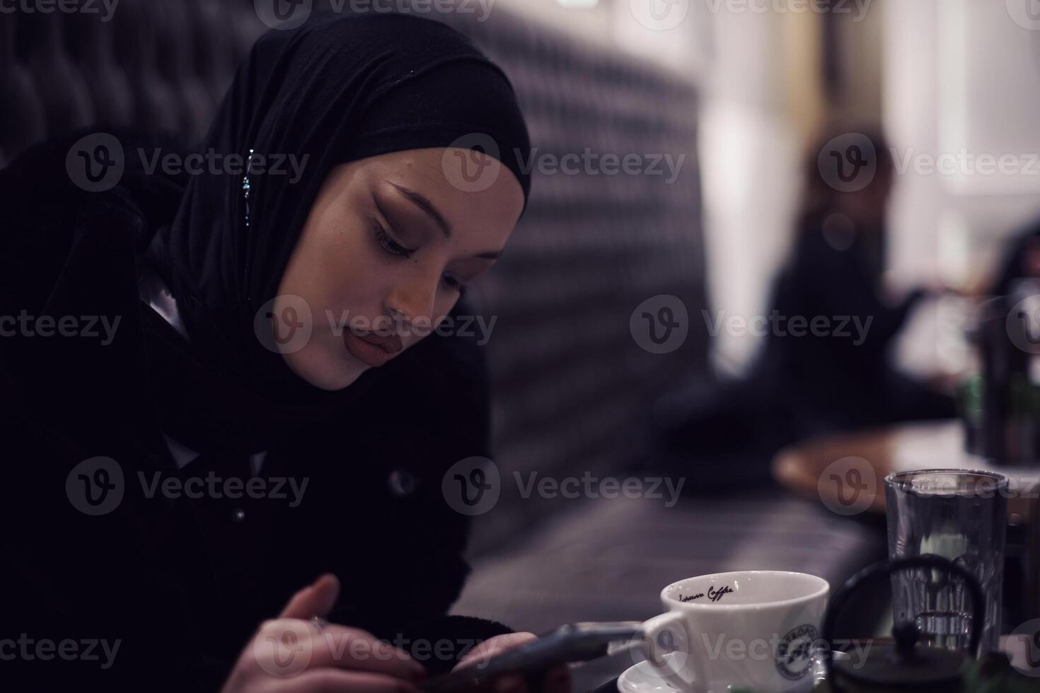 Muslim woman walking on an urban city street on a cold winter night wearing hijab photo