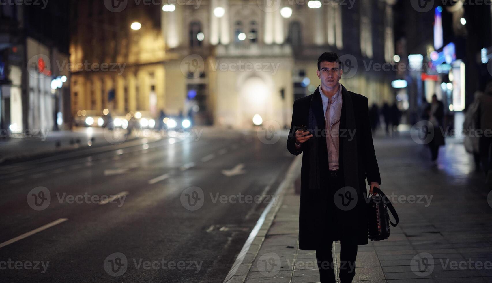 Smiling Meedle Eastern man walking down street near modern office building, photo