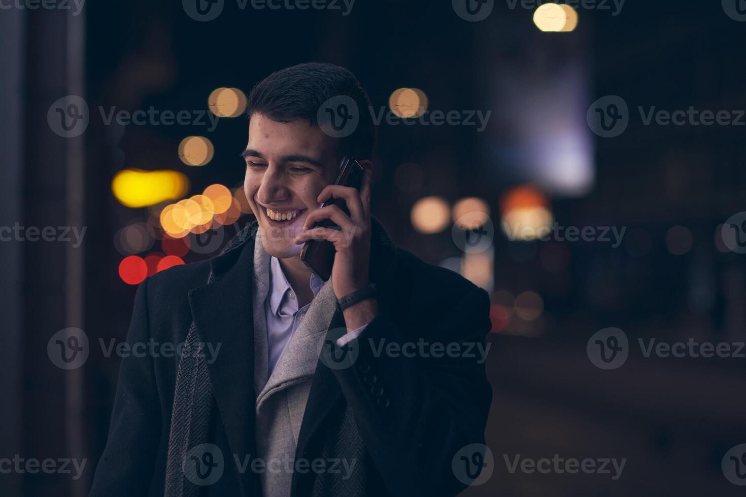 Smiling Meedle Eastern man walking down street near modern office building, photo