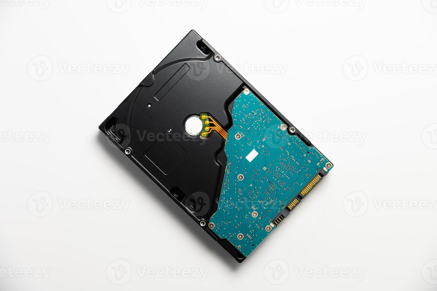 Disassembled interior of a hard drive, which is the computer's storage device. Broken hard drive on white background photo