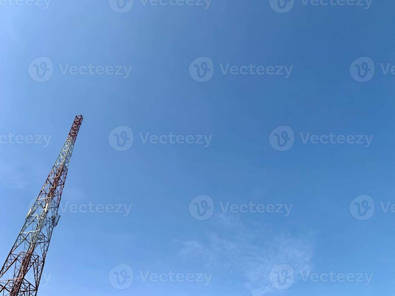 a large tower with a red and white antenna photo