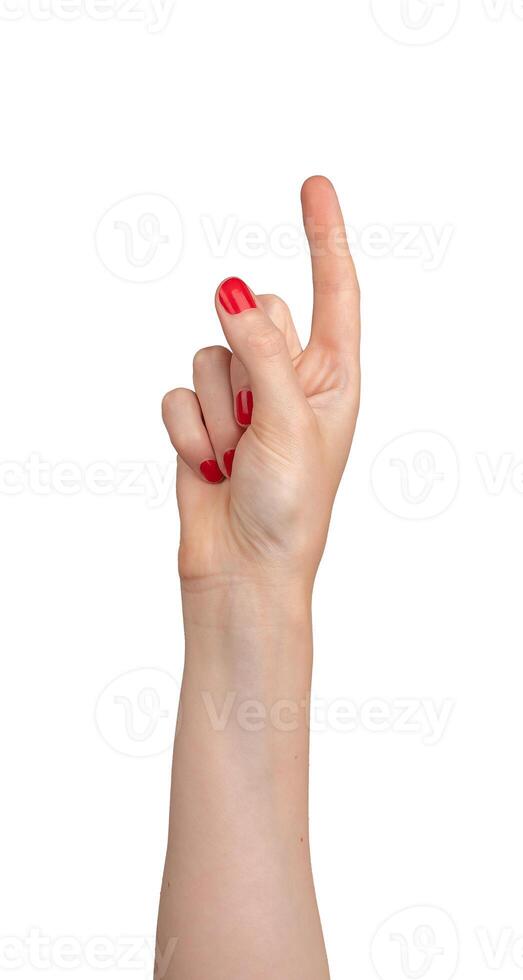 Female hand pointing, index finger extended and varnished in red, signaling direction. Right hand photo