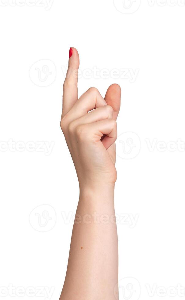 Index finger pointing to indicate direction, with red nail varnish on a Caucasian woman's right hand photo