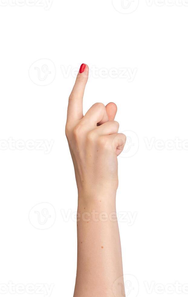 Female hand pointing, index finger extended and varnished in red, signaling direction. Right hand photo