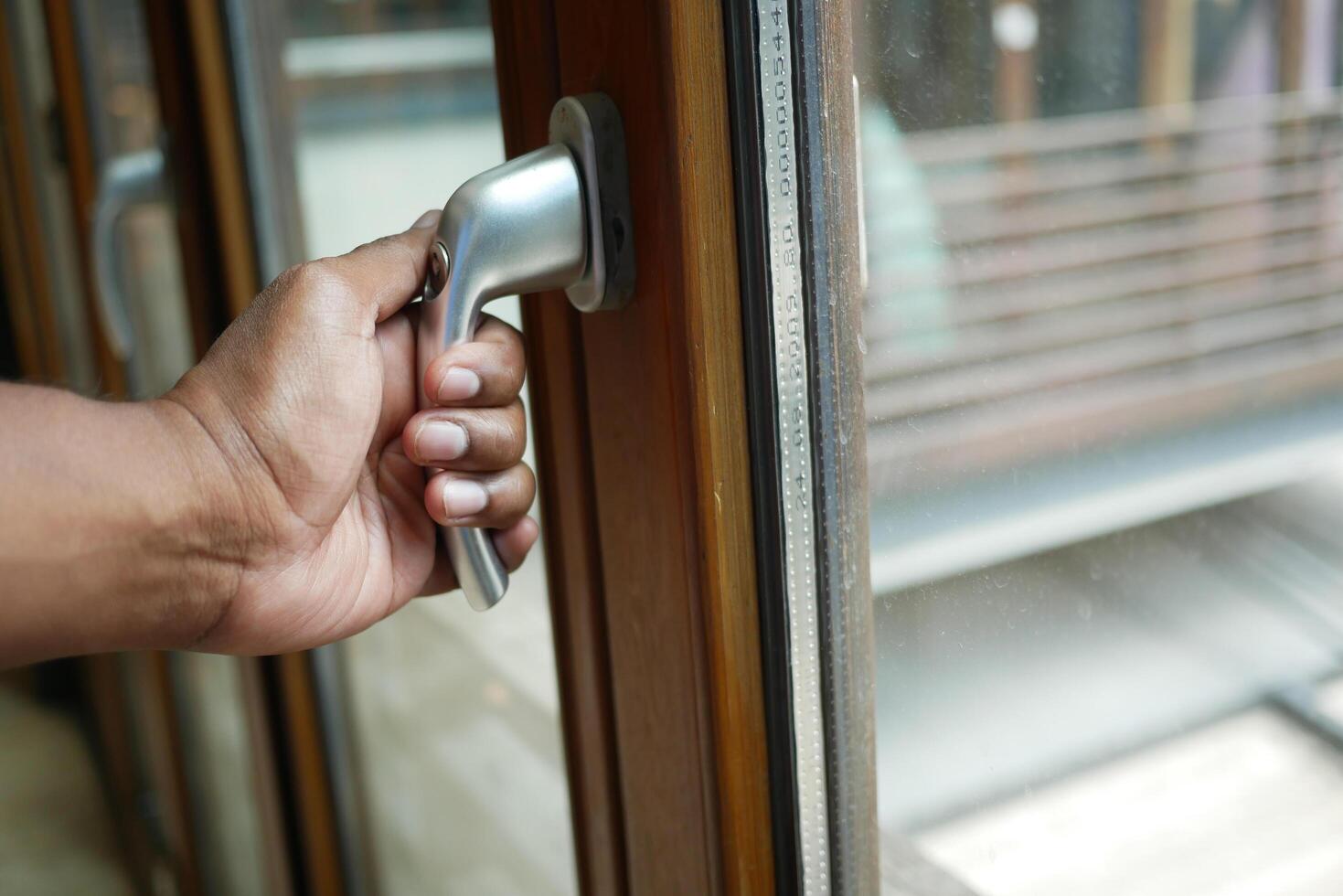 hand open gray plastic pvc window at home at early morning photo