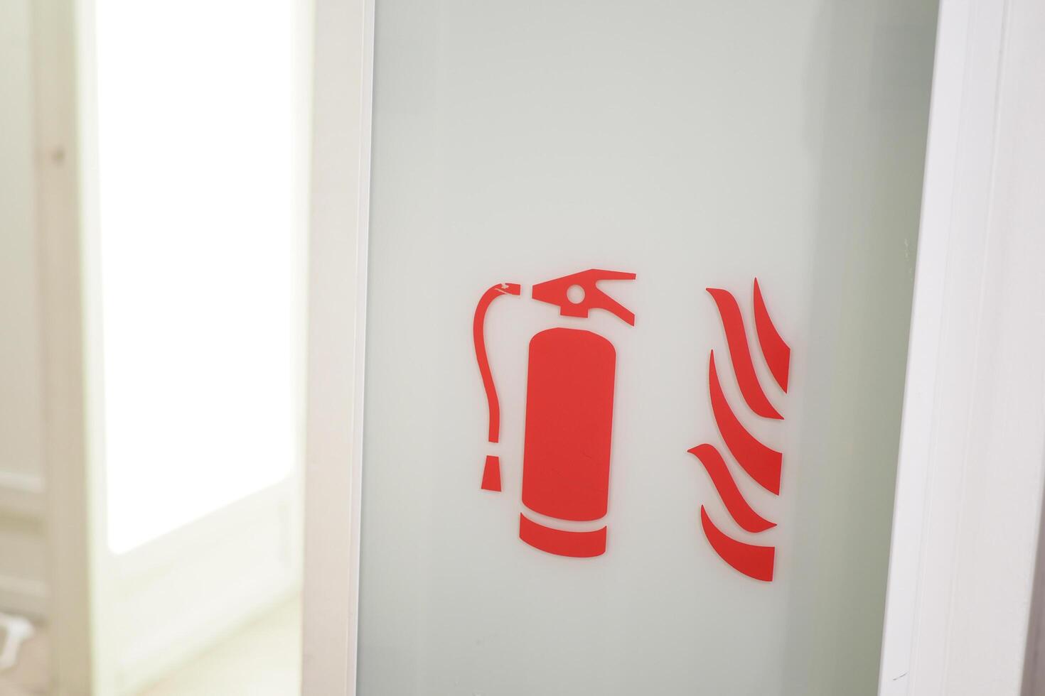 The store aisle is marked with a sign indicating the presence of a fire extinguisher and fire hose photo