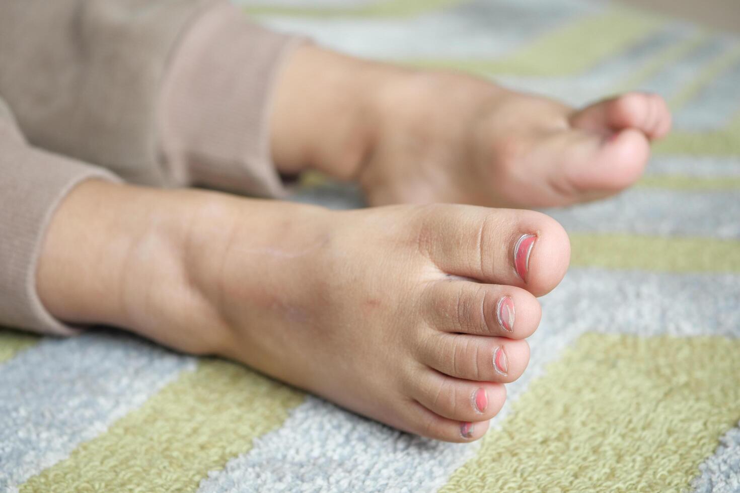 Bare feet of a child on a wooden floor represent innocence and playful moments at home photo